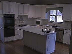 Spacious Kitchen Includes Serving Island and Hardwood Floors